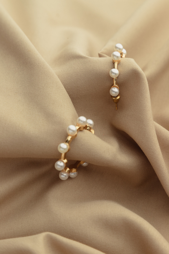 Gold Earrings with Pearls on Brown Satin Cloth